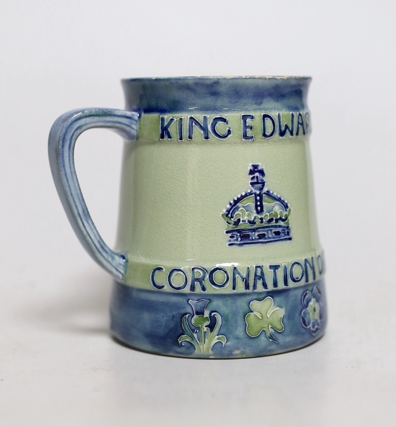 A Moorcroft Coronation of Edward VII and Queen Alexandra 1902. Tapering mug decorated in blue with underside inscription, From Mr and Mrs Lazenby Liberty, Lee Manor, Bucks and monograms. no. 112 of 250, 9.5cm tall